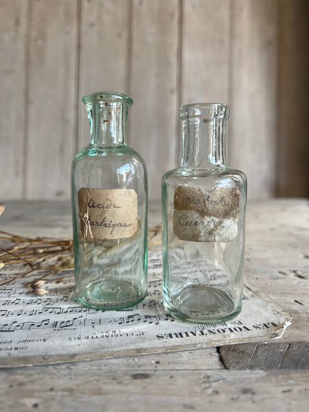 A pair of small vintage apothecary bottles