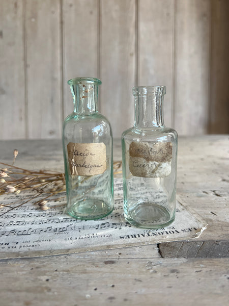 A pair of small vintage apothecary bottles