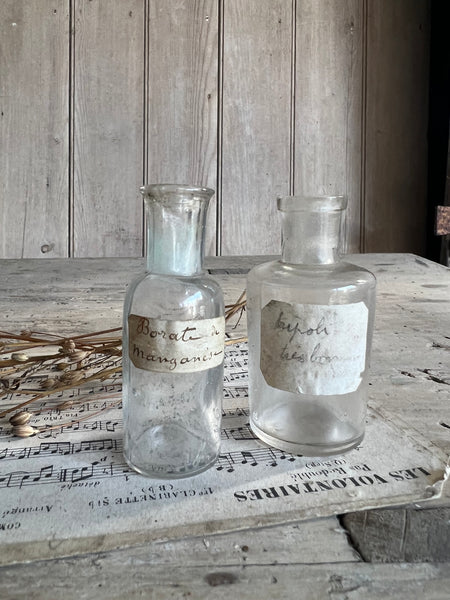 A pair of small vintage apothecary bottles