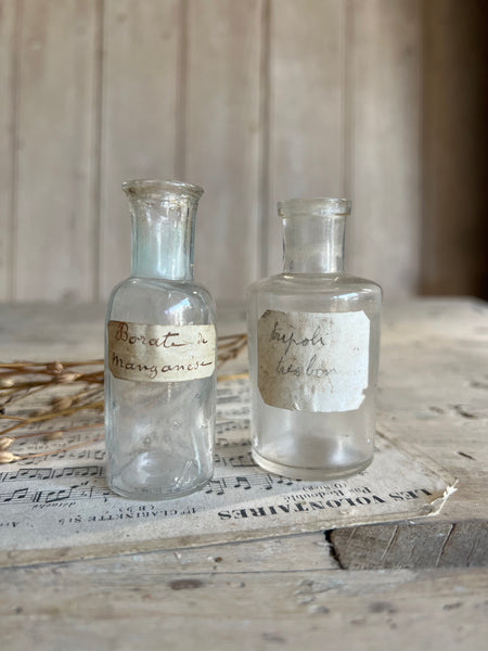 A pair of small vintage apothecary bottles