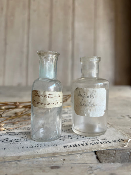 A pair of small vintage apothecary bottles